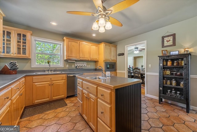kitchen featuring appliances with stainless steel finishes, light brown cabinets, ceiling fan, and a sink
