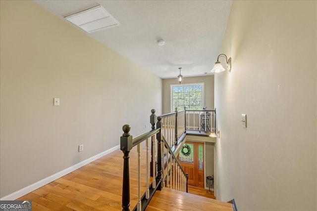 stairway featuring wood finished floors and baseboards