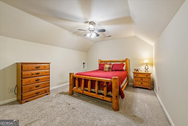 carpeted bedroom with vaulted ceiling, visible vents, a ceiling fan, and baseboards