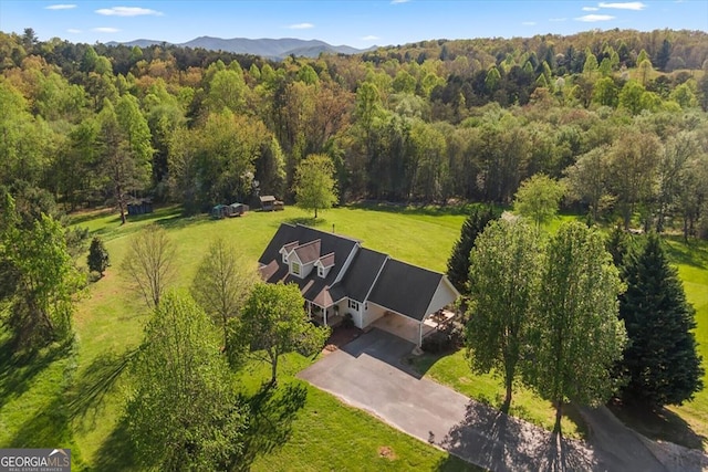 aerial view with a mountain view and a view of trees