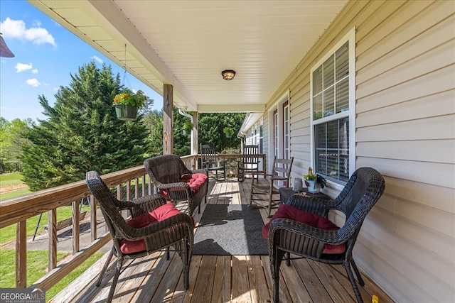 deck with an outdoor hangout area and covered porch