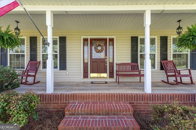 view of exterior entry with covered porch