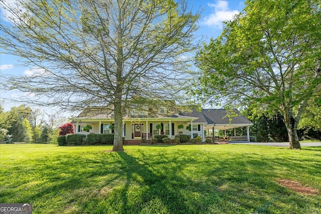view of front of home featuring a carport, a front lawn, and covered porch