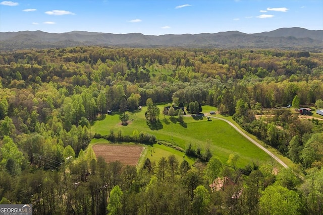 birds eye view of property with a forest view and a mountain view