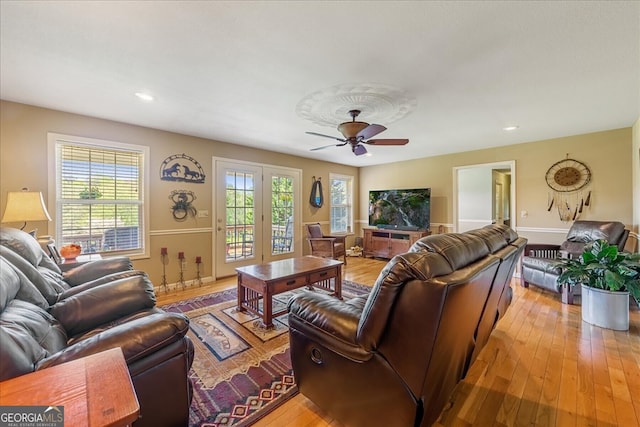 living room with recessed lighting, light wood-style flooring, a ceiling fan, and baseboards