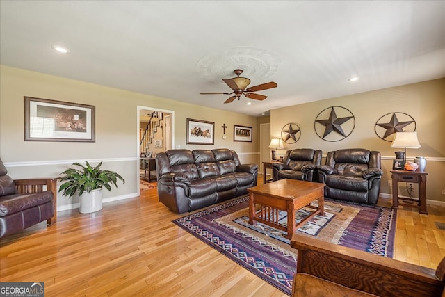 living room featuring baseboards, recessed lighting, wood finished floors, stairway, and ceiling fan