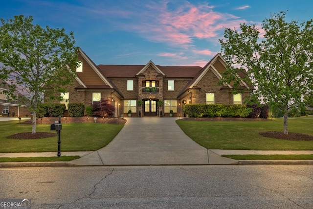 401 Sara Ct, Loganville, GA 30052 - view of front facade featuring a lawn, concrete driveway, and stone siding