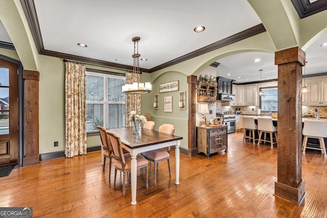 401 Sara Ct, Loganville, GA 30052 - dining area featuring crown molding, recessed lighting, an inviting chandelier, and ornate columns