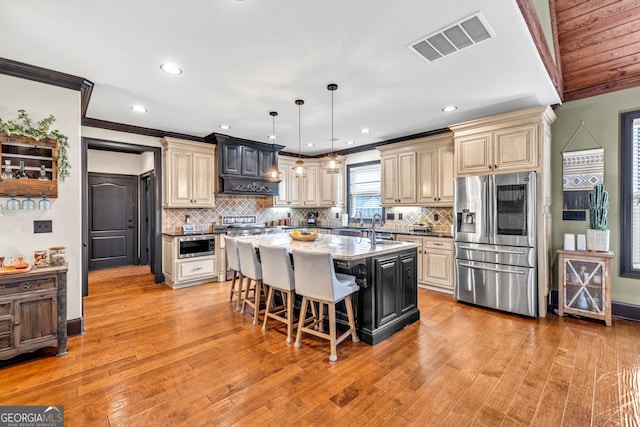 401 Sara Ct, Loganville, GA 30052 - kitchen featuring visible vents, crown molding, appliances with stainless steel finishes, cream cabinets, and a sink