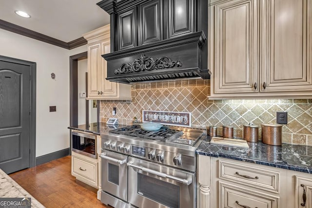 401 Sara Ct, Loganville, GA 30052 - kitchen with decorative backsplash, cream cabinets, and double oven range