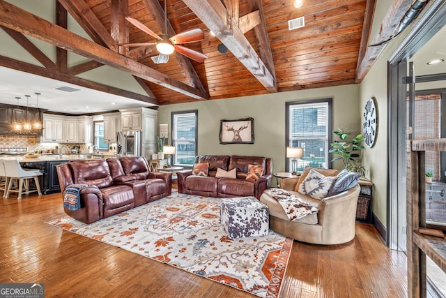401 Sara Ct, Loganville, GA 30052 - living area with ceiling fan, lofted ceiling with beams, light wood-type flooring, and visible vents