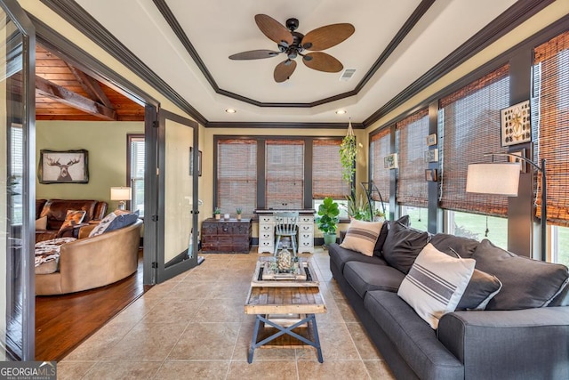 401 Sara Ct, Loganville, GA 30052 - tiled living room with crown molding, a ceiling fan, a tray ceiling, and visible vents