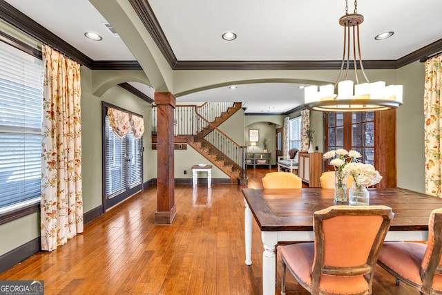 401 Sara Ct, Loganville, GA 30052 - dining room featuring arched walkways, ornamental molding, baseboards, and a notable chandelier