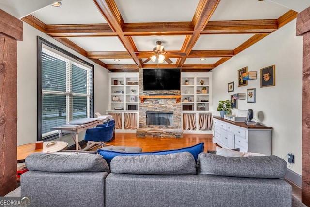 401 Sara Ct, Loganville, GA 30052 - living area with wood finished floors, beam ceiling, a stone fireplace, a ceiling fan, and coffered ceiling