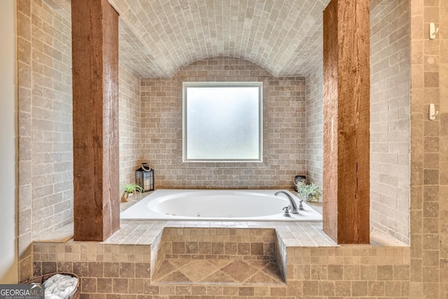 401 Sara Ct, Loganville, GA 30052 - bathroom with a tub with jets and vaulted ceiling