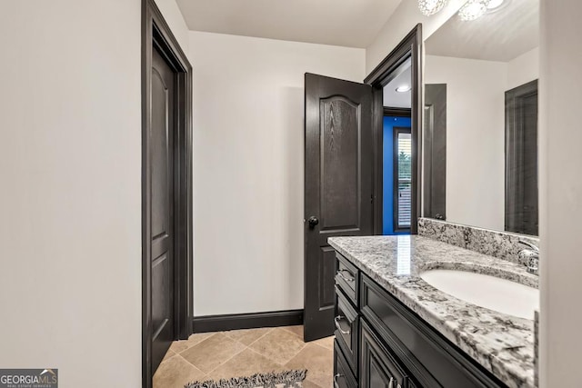 401 Sara Ct, Loganville, GA 30052 - bathroom featuring tile patterned floors, baseboards, and vanity