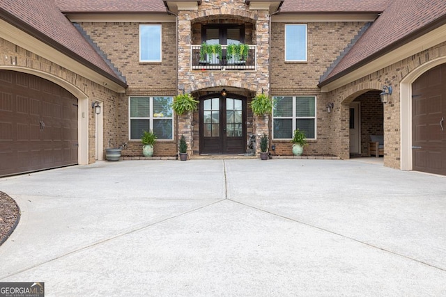 401 Sara Ct, Loganville, GA 30052 - property entrance with brick siding, an attached garage, driveway, and french doors