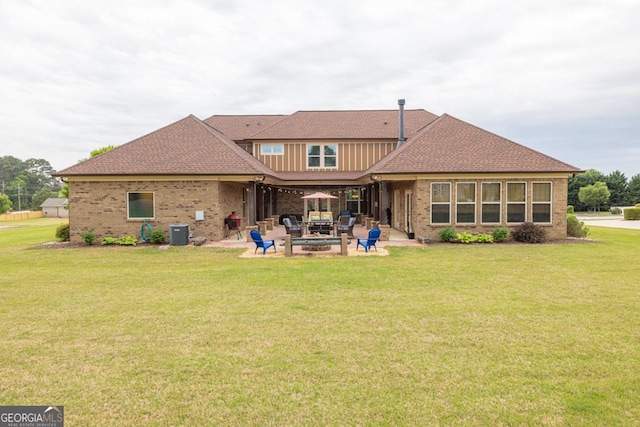 401 Sara Ct, Loganville, GA 30052 - rear view of house featuring a lawn, brick siding, central AC, and a patio area