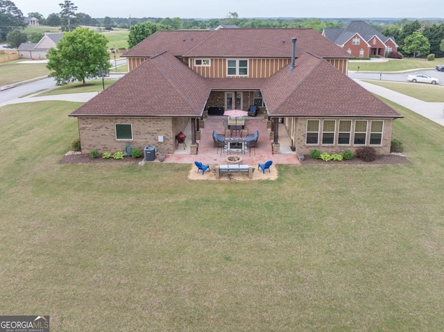 401 Sara Ct, Loganville, GA 30052 - rear view of house with a lawn, a patio, a shingled roof, and brick siding