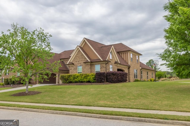 401 Sara Ct, Loganville, GA 30052 - view of front of house with roof with shingles, driveway, a front lawn, and brick siding