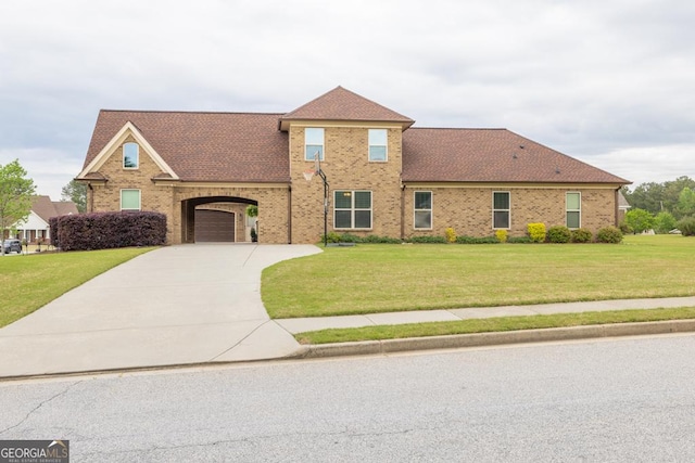 401 Sara Ct, Loganville, GA 30052 - view of front of home with roof with shingles, concrete driveway, brick siding, and a front yard