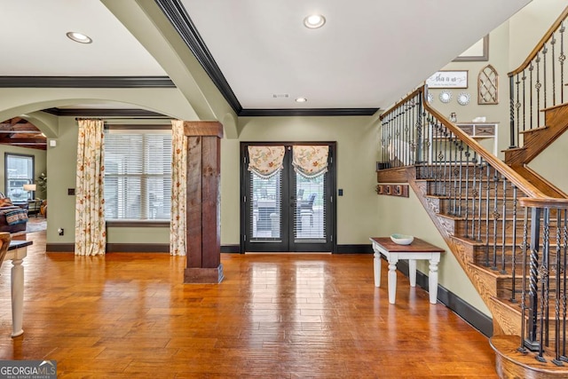 401 Sara Ct, Loganville, GA 30052 - foyer entrance with crown molding, baseboards, stairway, french doors, and arched walkways