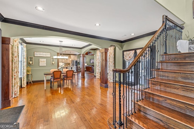 401 Sara Ct, Loganville, GA 30052 - stairway featuring arched walkways, ornamental molding, baseboards, and decorative columns