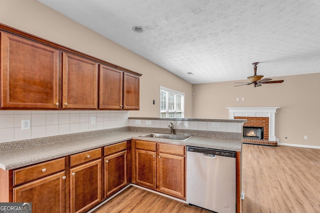 362 Interlake Pass, Mcdonough, GA 30252 - kitchen featuring stainless steel dishwasher, a sink, light wood-style floors, a ceiling fan, and a peninsula