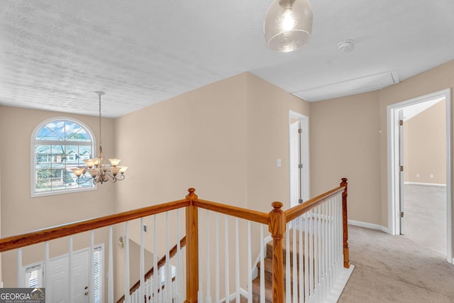 362 Interlake Pass, Mcdonough, GA 30252 - corridor with attic access, an upstairs landing, carpet, a chandelier, and baseboards
