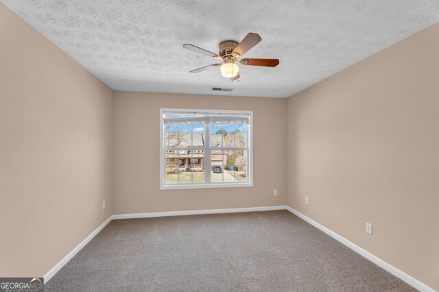 362 Interlake Pass, Mcdonough, GA 30252 - spare room with carpet floors, ceiling fan, baseboards, and a textured ceiling