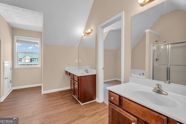362 Interlake Pass, Mcdonough, GA 30252 - full bath with wood finished floors, two vanities, a stall shower, lofted ceiling, and baseboards