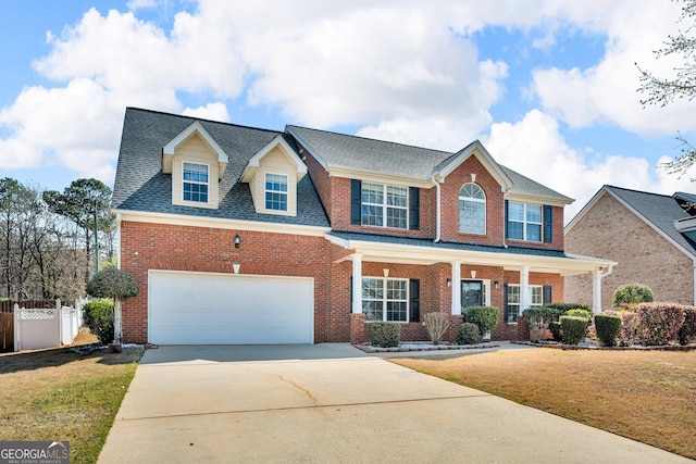 362 Interlake Pass, Mcdonough, GA 30252 - view of front facade with concrete driveway, brick siding, covered porch, a shingled roof, and an attached garage