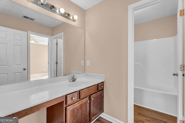 362 Interlake Pass, Mcdonough, GA 30252 - bathroom featuring vanity, wood finished floors, a ceiling fan, and shower / tub combination