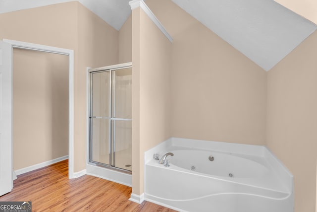 362 Interlake Pass, Mcdonough, GA 30252 - full bathroom with a jetted tub, a shower stall, wood finished floors, vaulted ceiling, and baseboards