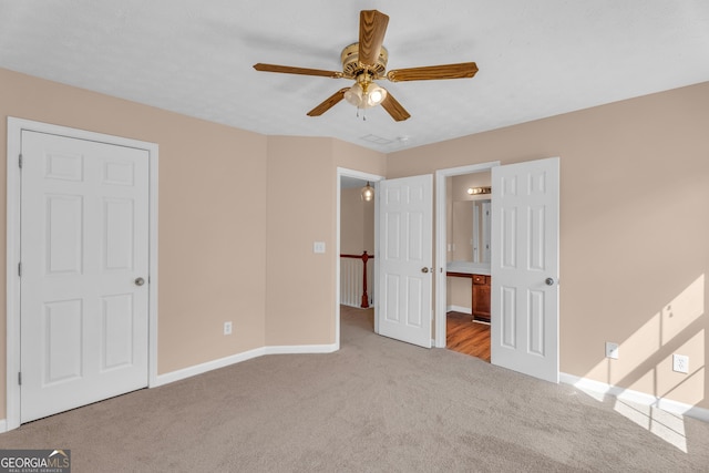 362 Interlake Pass, Mcdonough, GA 30252 - unfurnished bedroom with carpet floors, baseboards, connected bathroom, and ceiling fan