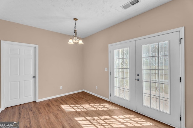 362 Interlake Pass, Mcdonough, GA 30252 - entryway with a chandelier, wood finished floors, french doors, and baseboards