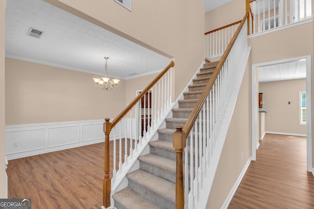 362 Interlake Pass, Mcdonough, GA 30252 - stairs with wood finished floors, a chandelier, crown molding, and baseboards