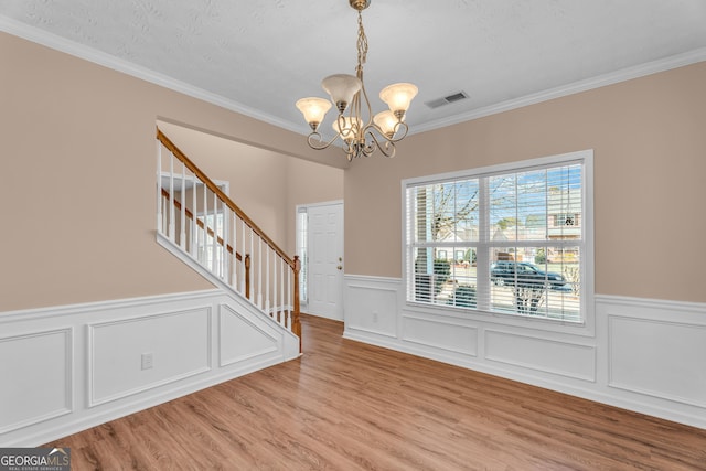 362 Interlake Pass, Mcdonough, GA 30252 - entryway with stairway, a chandelier, a wainscoted wall, ornamental molding, and wood finished floors