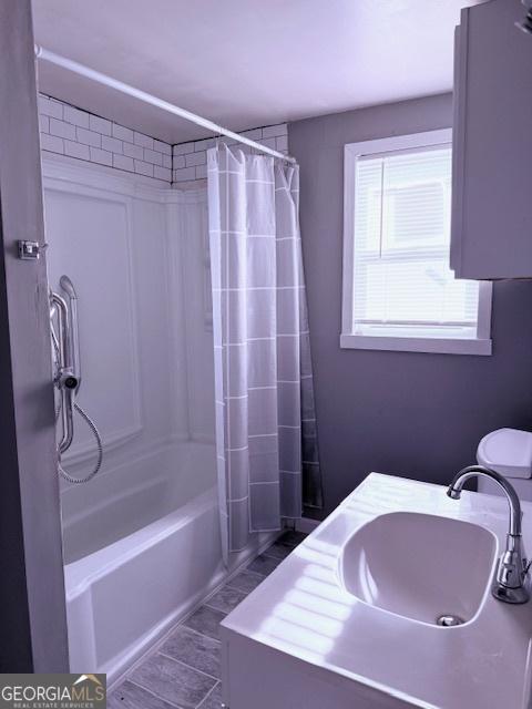 2832 Horseshoe Dr, Macon, GA 31211 - bathroom featuring a sink and shower / bathtub combination with curtain