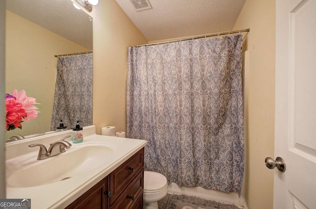 bathroom featuring curtained shower, visible vents, toilet, vanity, and a textured ceiling