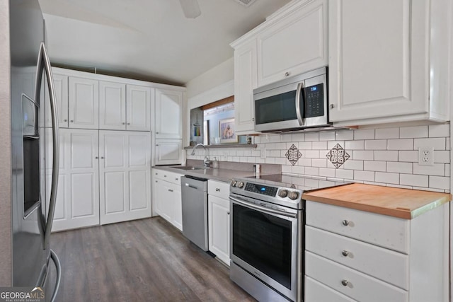 1144 Evergreen Dr NE, Atlanta, GA 30319 - kitchen featuring a sink, backsplash, white cabinetry, dark wood-type flooring, and appliances with stainless steel finishes