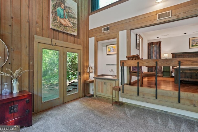 1144 Evergreen Dr NE, Atlanta, GA 30319 - doorway with carpet, visible vents, wood walls, and a sink