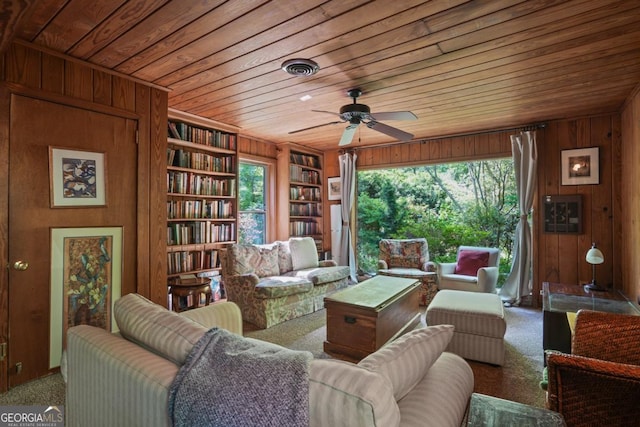 1144 Evergreen Dr NE, Atlanta, GA 30319 - living area with plenty of natural light, built in features, wood walls, wooden ceiling, and carpet floors