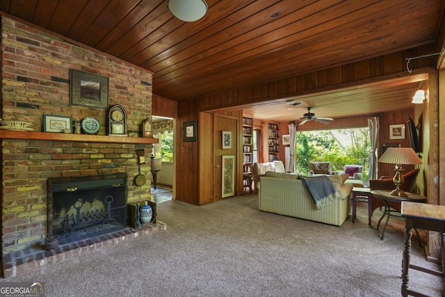 1144 Evergreen Dr NE, Atlanta, GA 30319 - living area with carpet flooring, a ceiling fan, a brick fireplace, wood walls, and wood ceiling