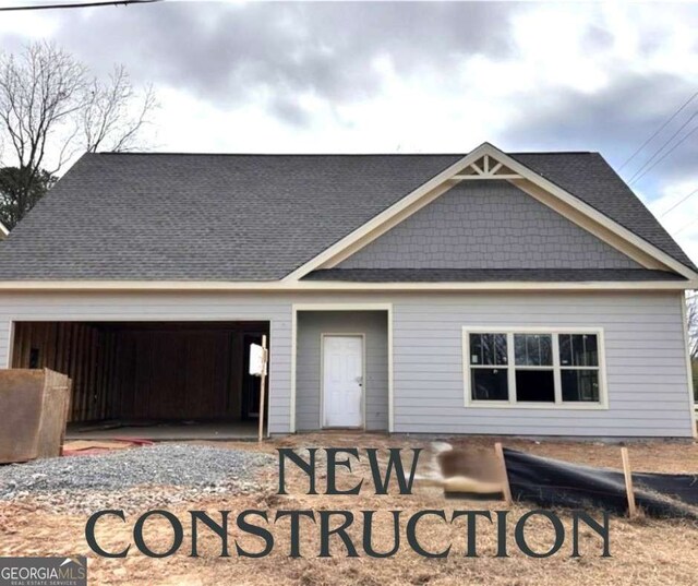 4755 Fowler St, Acworth, GA 30101 - view of front facade featuring an attached garage, driveway, and roof with shingles