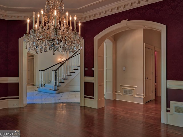 interior space featuring wood finished floors, visible vents, and arched walkways