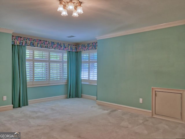 carpeted empty room with a notable chandelier, baseboards, crown molding, and visible vents