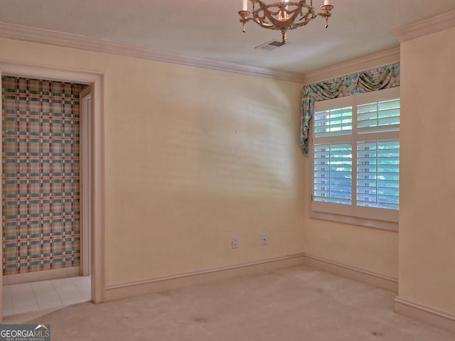 empty room featuring visible vents, ornamental molding, baseboards, a chandelier, and carpet flooring