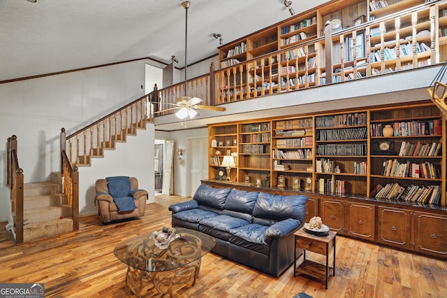 1009 Liberty Church Rd NE, Ranger, GA 30734 - living room featuring high vaulted ceiling, stairs, hardwood / wood-style floors, a ceiling fan, and crown molding