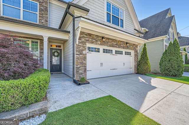 3699 School St, Chamblee, GA 30341 - view of home's exterior featuring stone siding, a garage, and driveway